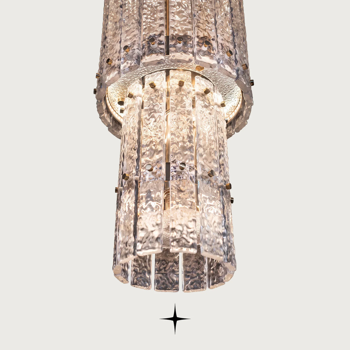 Detailed close-up of handmade rock-crystal textured glass diffusers on Three level Chime light