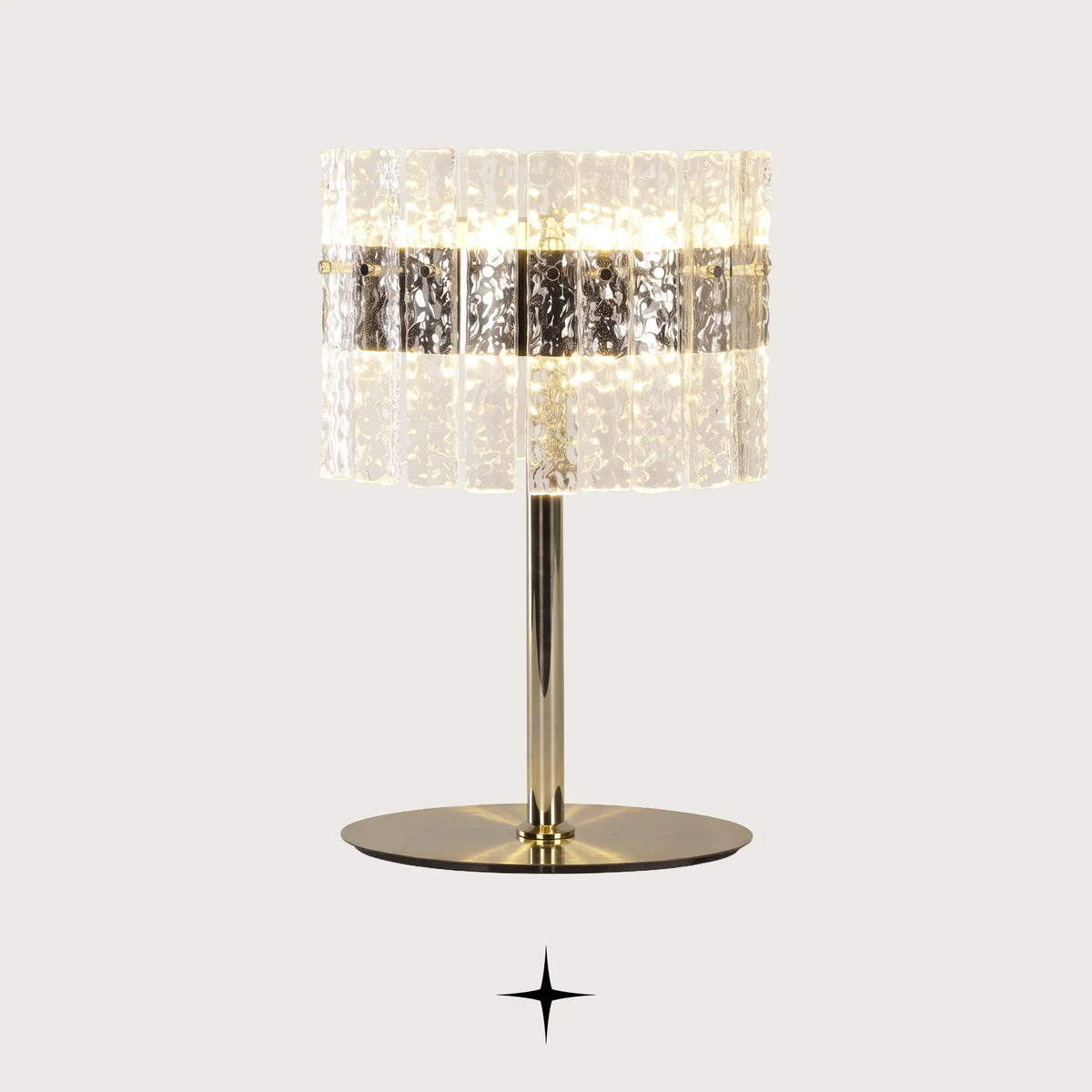 Chime rock crystal effect glass LED table lamp with golden nickel base on a light grey background