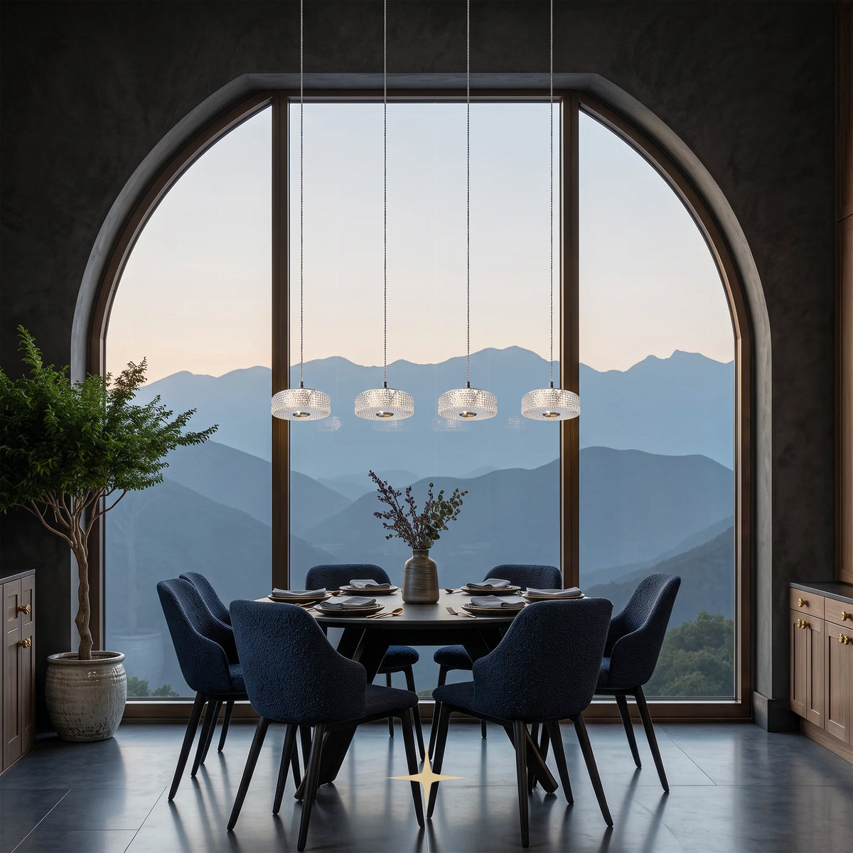 Row of Cleo glass pendant lights suspended over a modern round dining table in a luxury interior