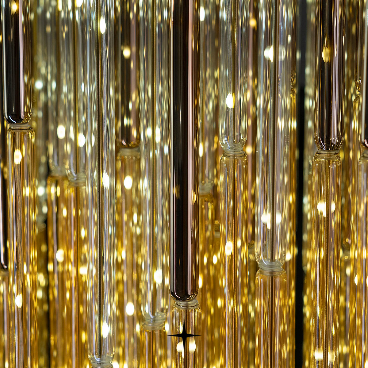 Close-up detail of shimmering golden glass strands on Echo chandelier