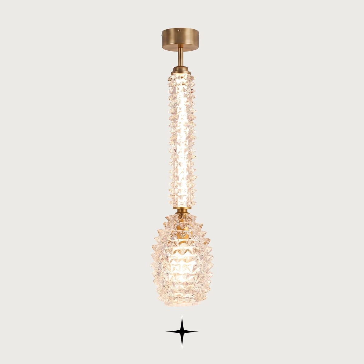 Elegant Sahara clear Murano glass vertical pendant light with golden stem on light grey background