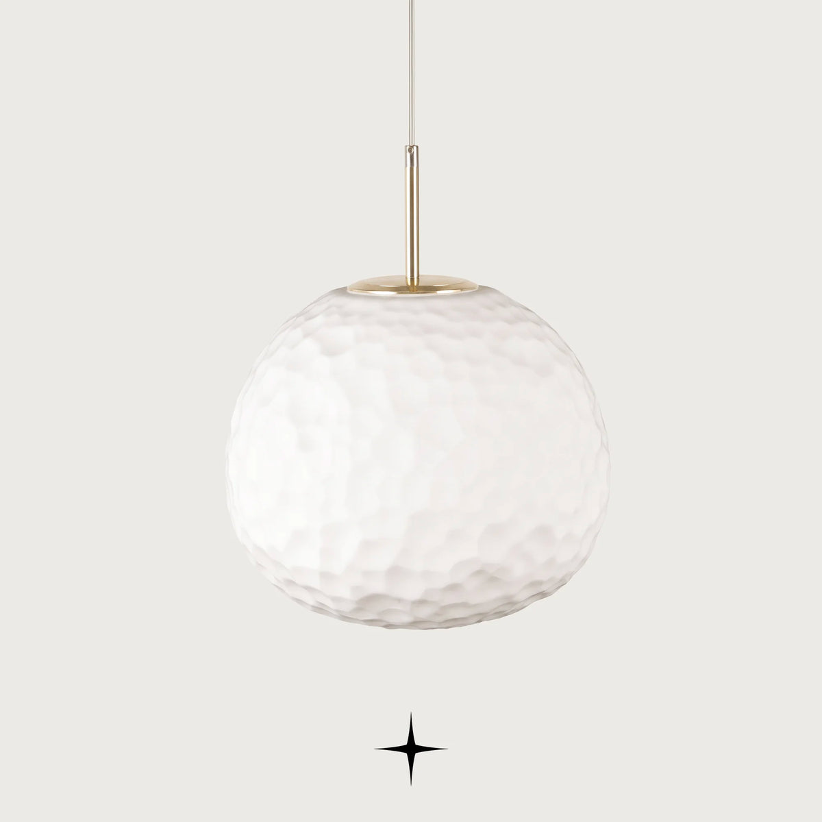 Elegant Zara single light pendant featuring a hammered texture white glass sphere and gold hardware on black background