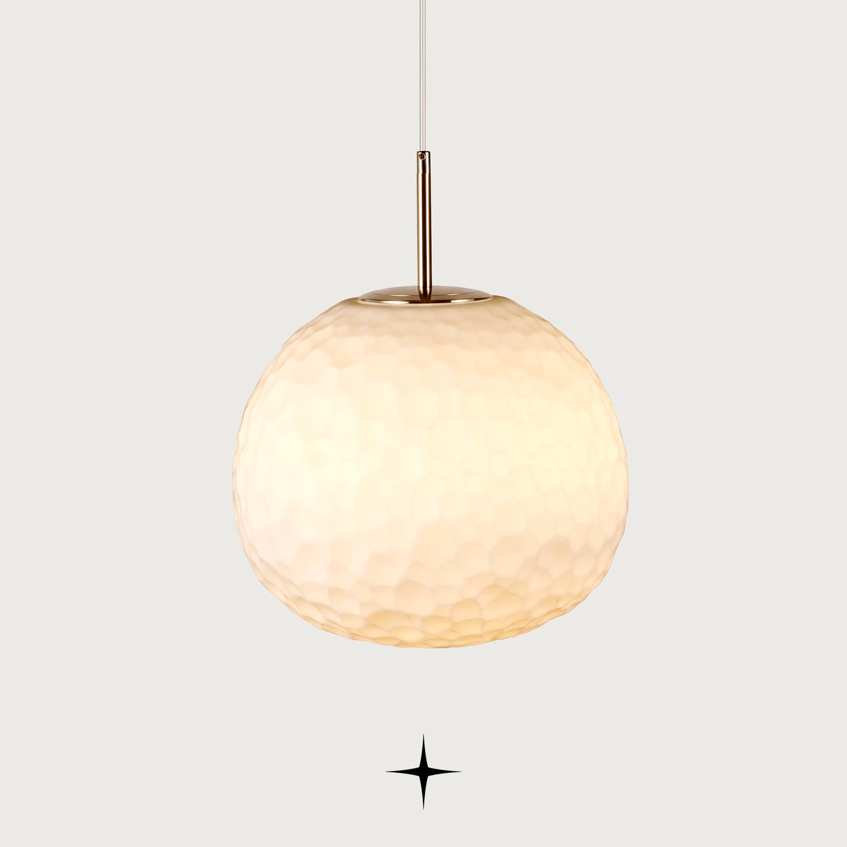 Elegant Zara single light pendant featuring a hammered texture white glass sphere and gold hardware on black background