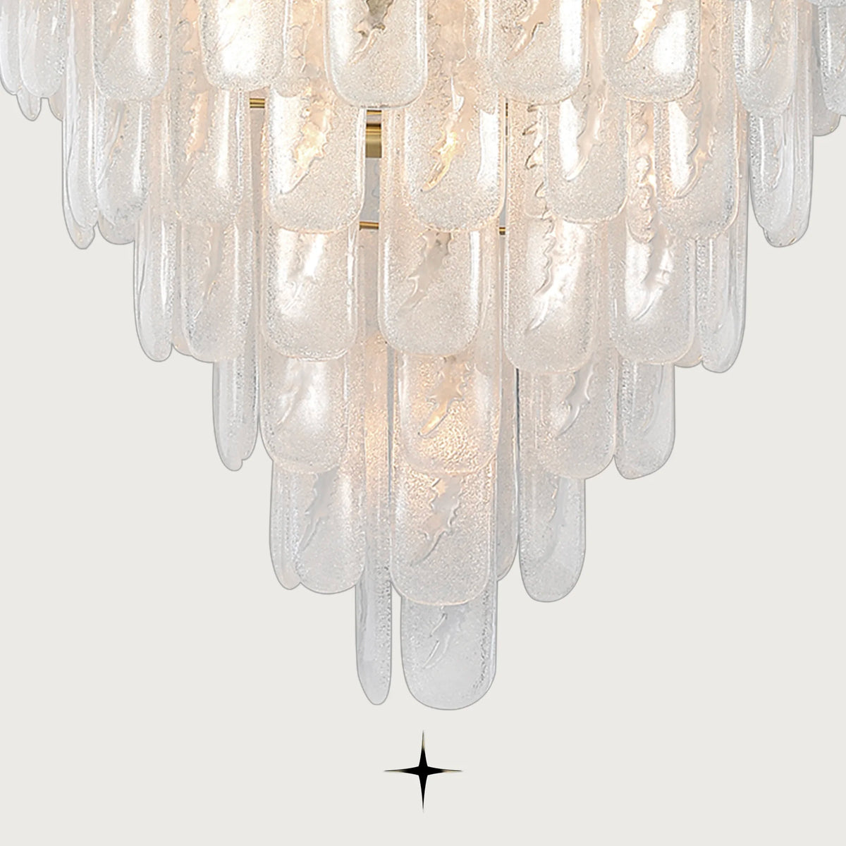 Close-up view of textured Murano glass blocks on Elena chandelier with light grey backdrop