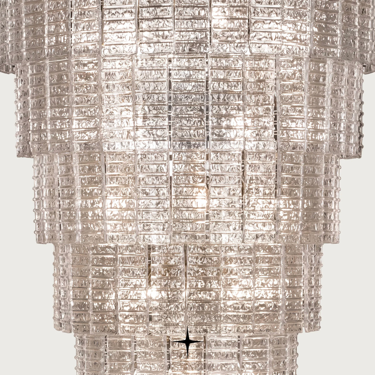 Close-up detail of textured glass prisms and light reflection on Grand Angel chandelier