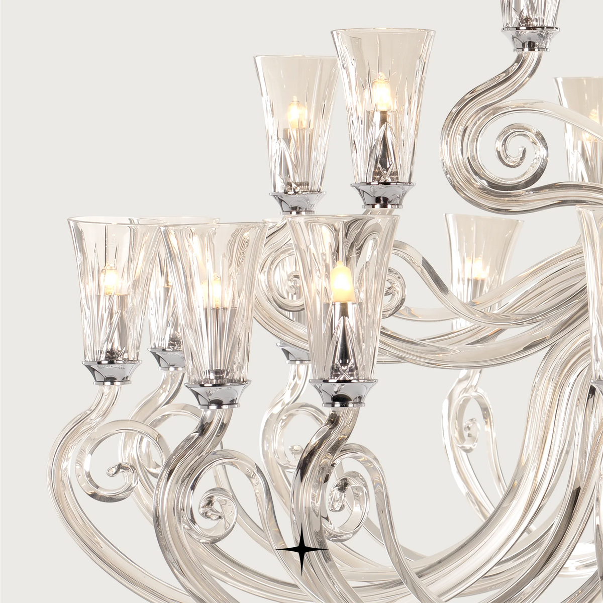 Grand Sophia Chandelier featuring chic elongated crystal arms available in five chandelier sizes and a wall fixture.