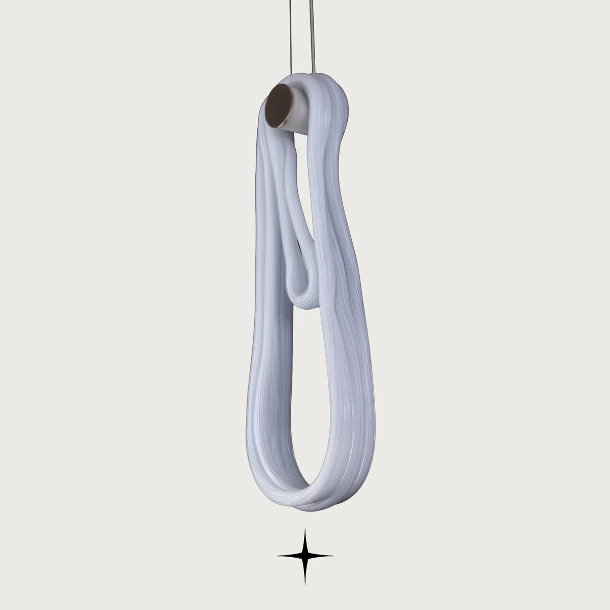 Close-up detail of a single illuminated twisted glass loop element on Lavadora fixture
