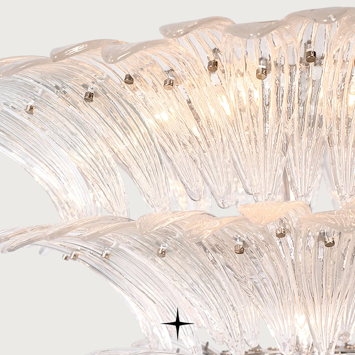 Detailed close-up of illuminated glass diffusers and gold accents on Lavish Crown fixture