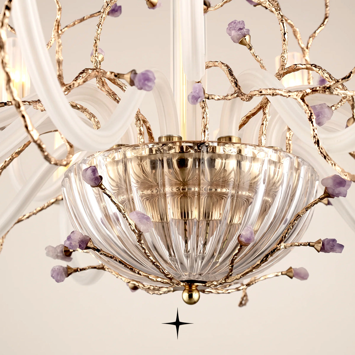 Close-up view of illuminated glass diffusers and brass branches on Lavish Madison chandelier