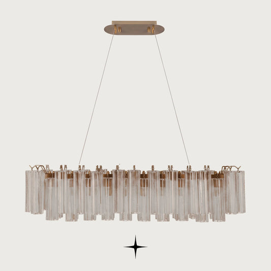 Linear Astra horizontal brass chandelier with fluted ribbed glass tubes on light grey background