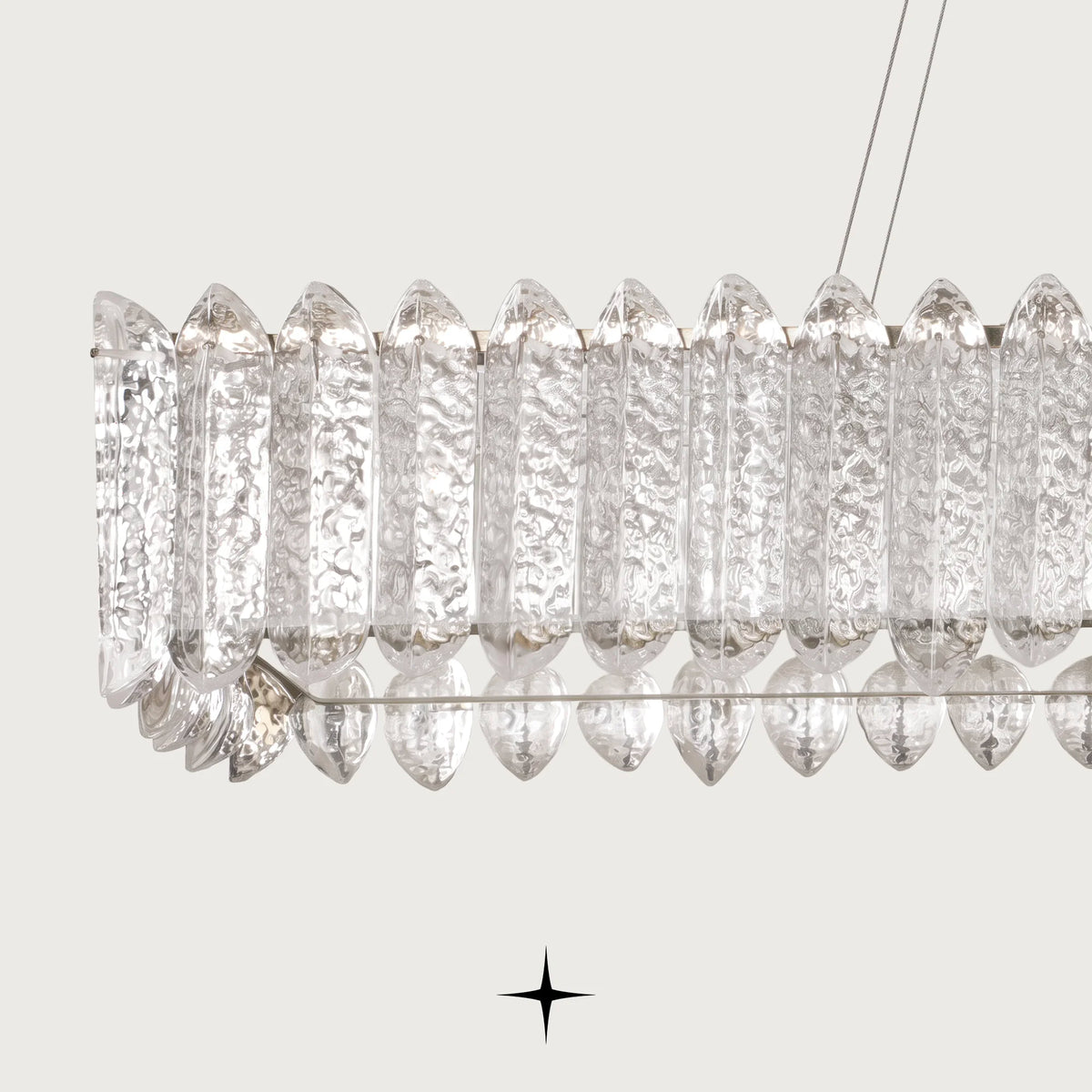 Close up detail of clear textured Murano glass pieces and gold hardware on Linear Calgary chandelier
