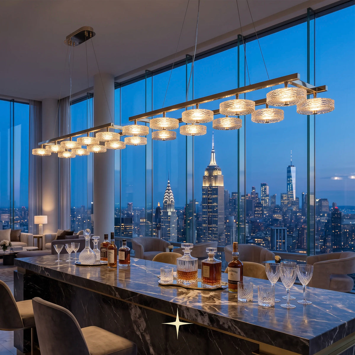 Linear Charlotte modern island chandelier with golden nickel frame and Murano glass discs hangs over a marble bar in a luxury high-rise apartment, with a New York City skyline at dusk visible through the large windows.