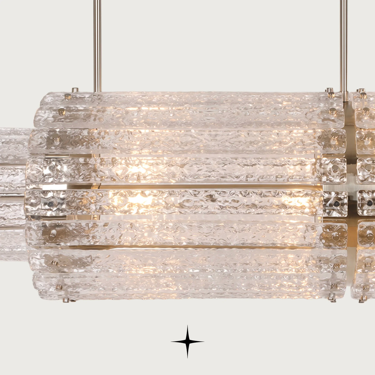 Close-up detail of handmade rock-crystal textured glass diffusers on Linear Chime chandelier