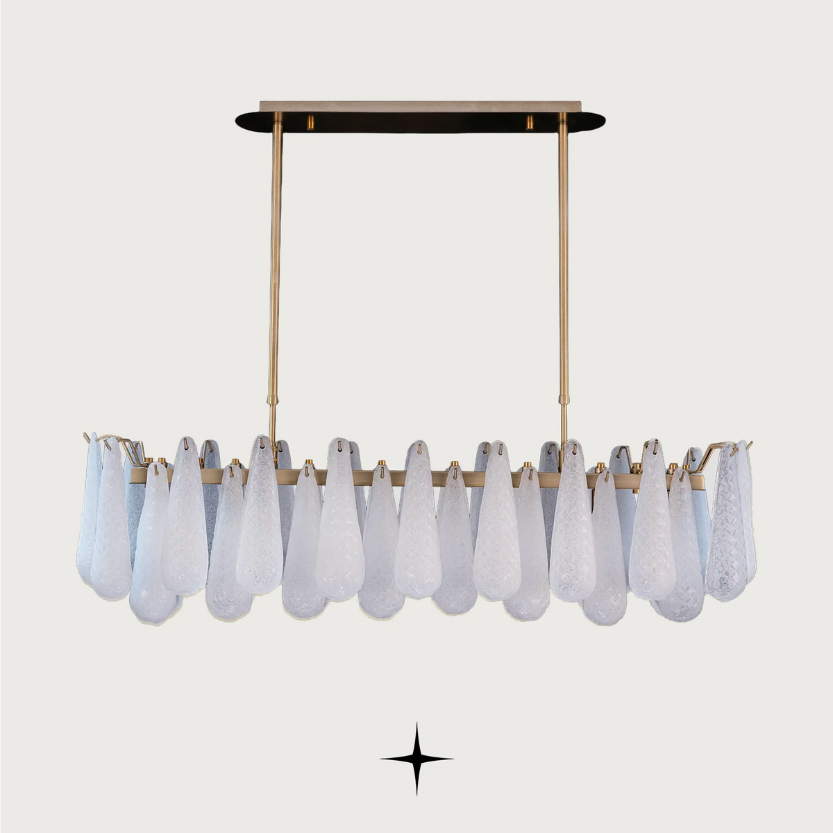 Linear Miranda horizontal brass chandelier with textured glass droplets on light grey background
