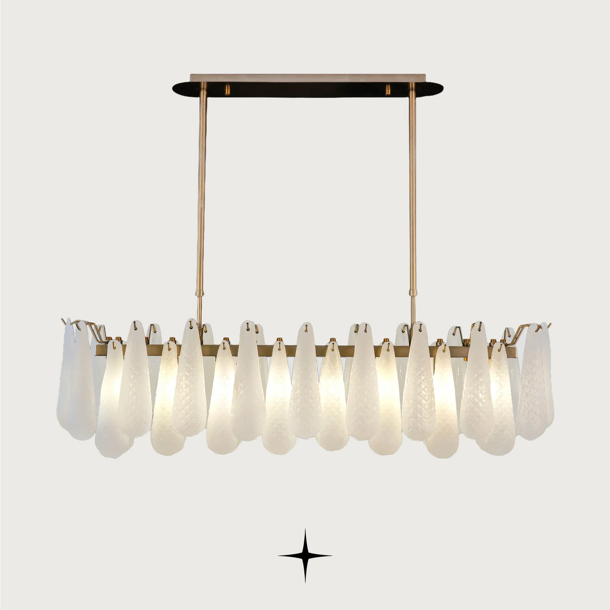 Linear Miranda horizontal brass chandelier with textured glass droplets on light grey background