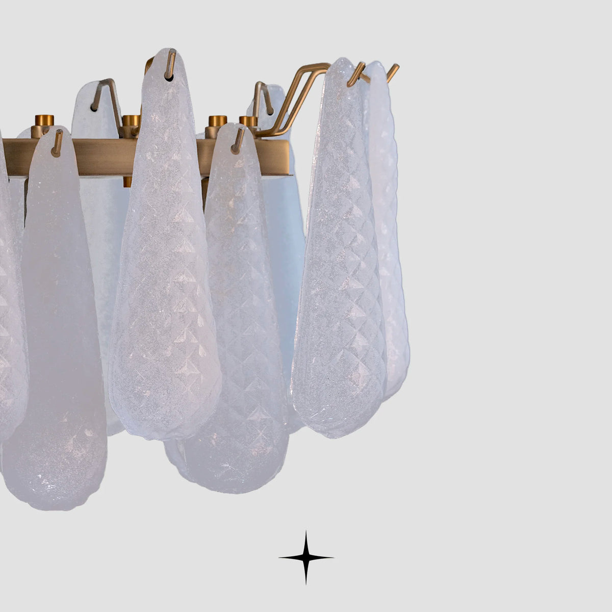 Close-up detail of illuminated textured glass droplets on Linear Miranda brass frame