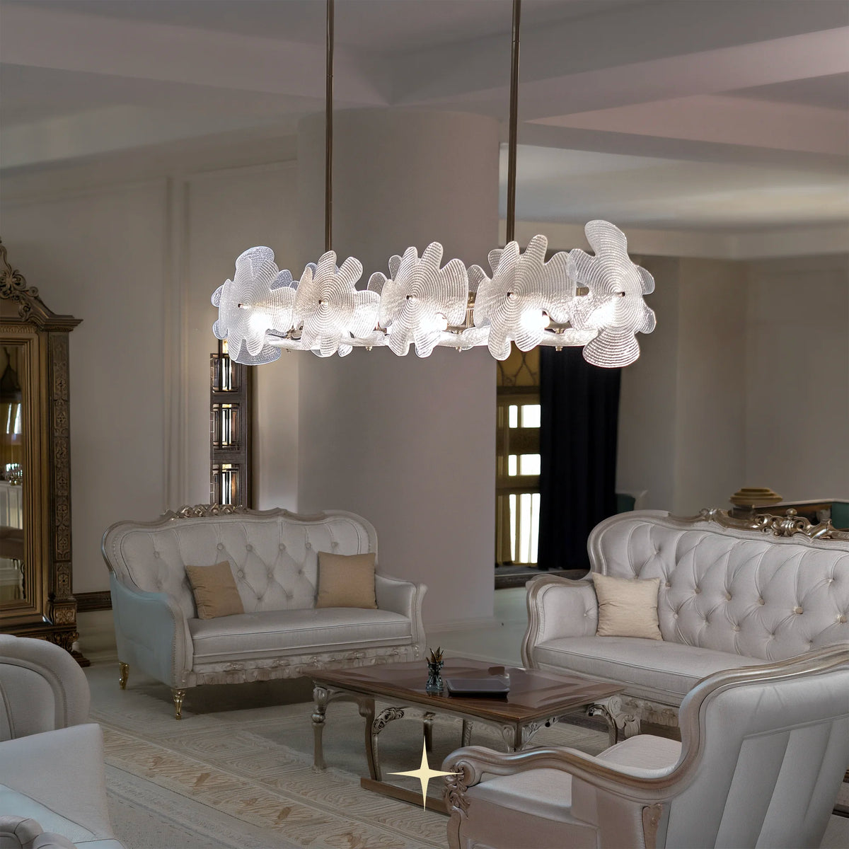 A modern nike chandelier with a cluster of white, flower-like textured glass shades hangs in a luxurious, elegant living room with cream tufted sofas and a glass coffee table.