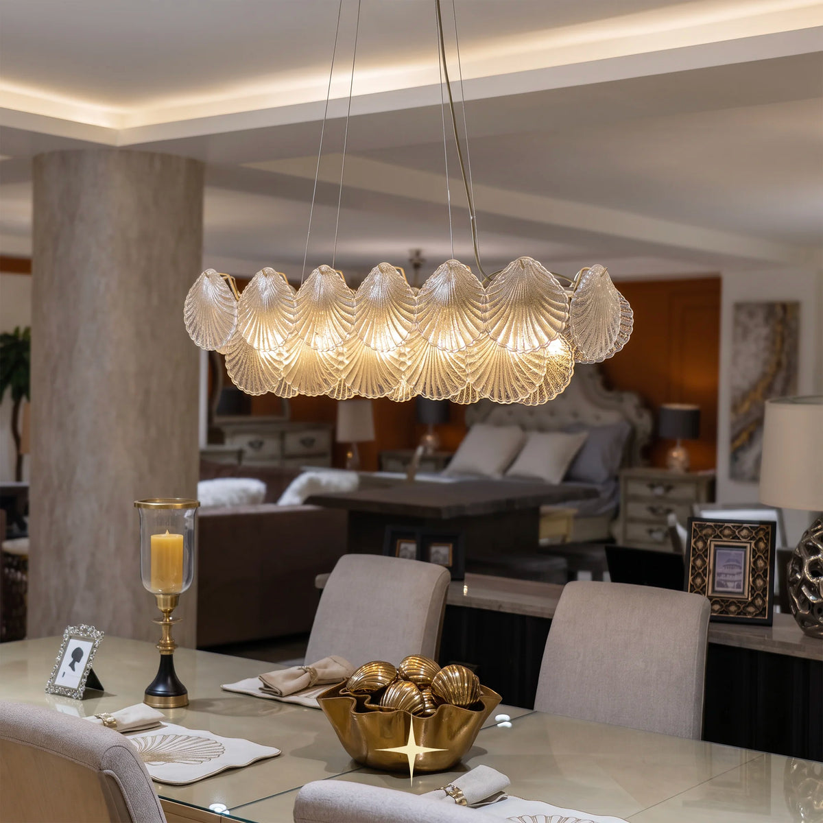 Linear Shellina seashell glass chandelier illuminated over a large modern dining table