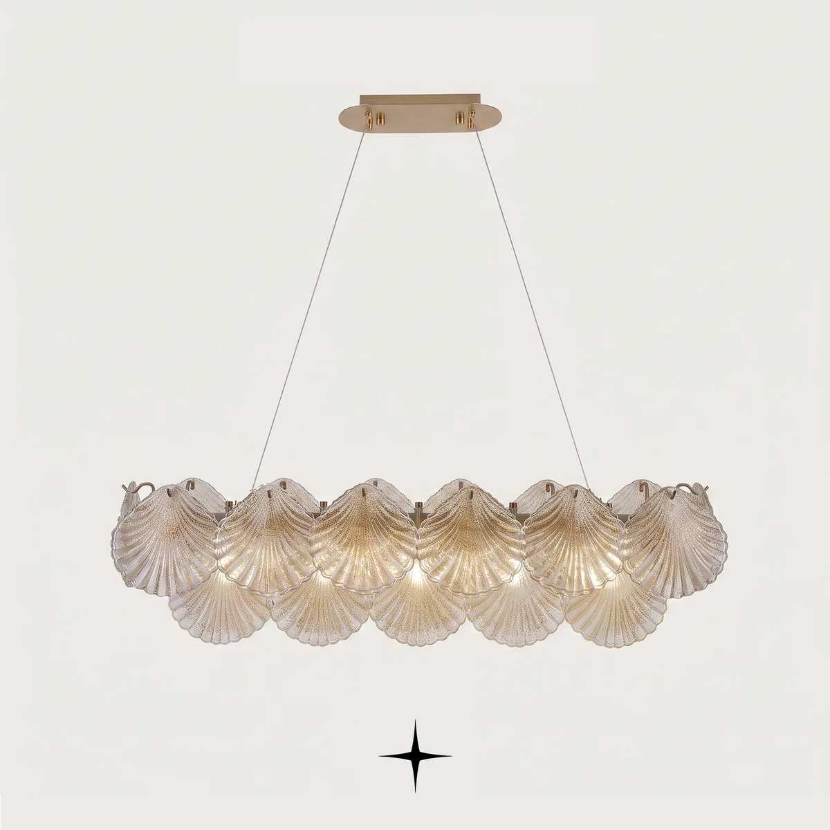Close-up detail of illuminated textured seashell glass diffusers on Linear Shellina fixture
