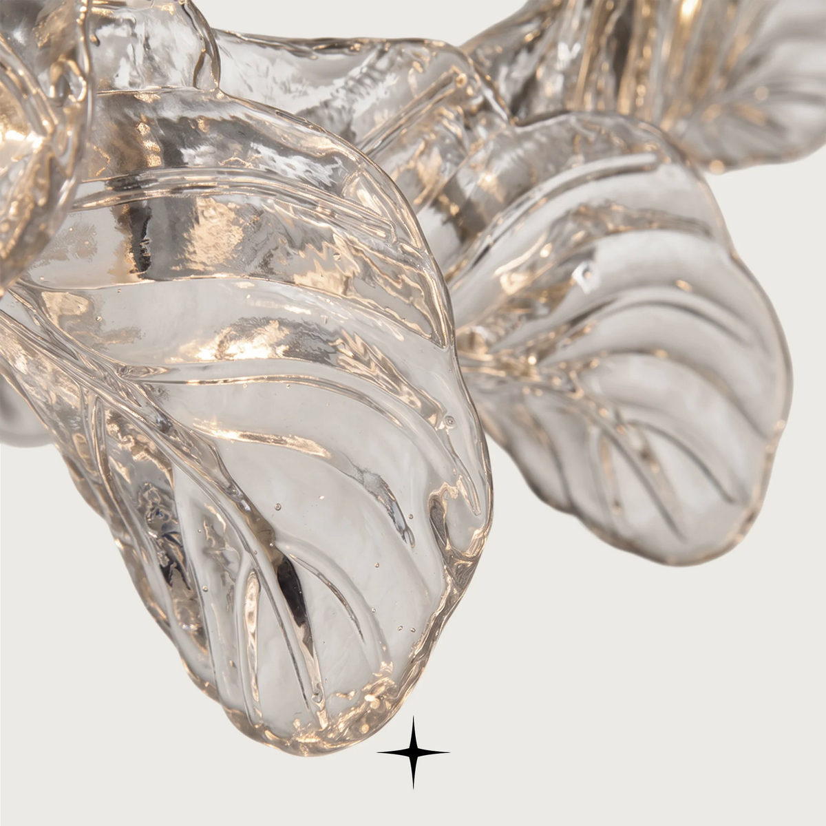 Top-angle view of delicate clear crystal leaf panels on the Madam chandelier