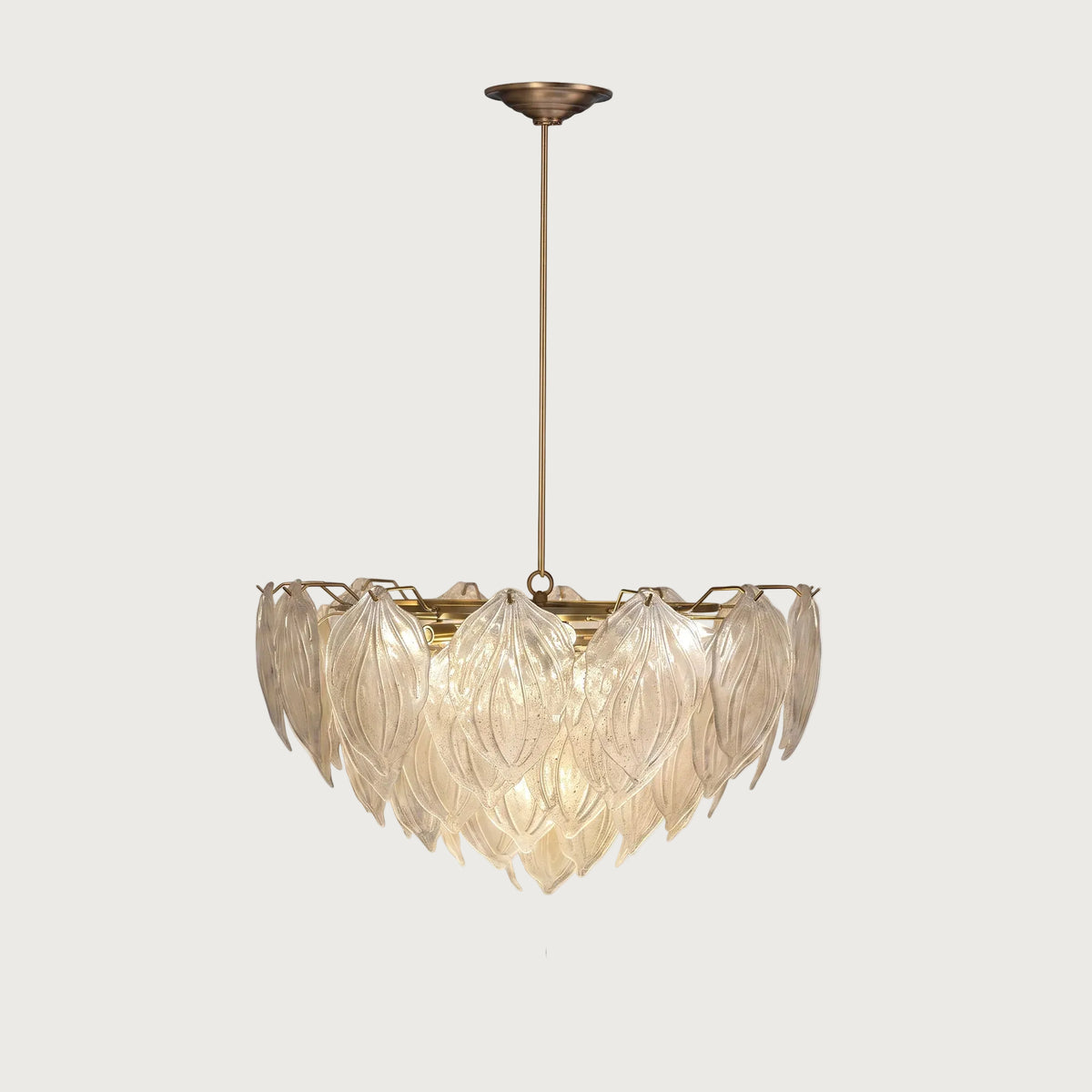 Mellow layered textured glass leaf chandelier with brass stem on light grey background