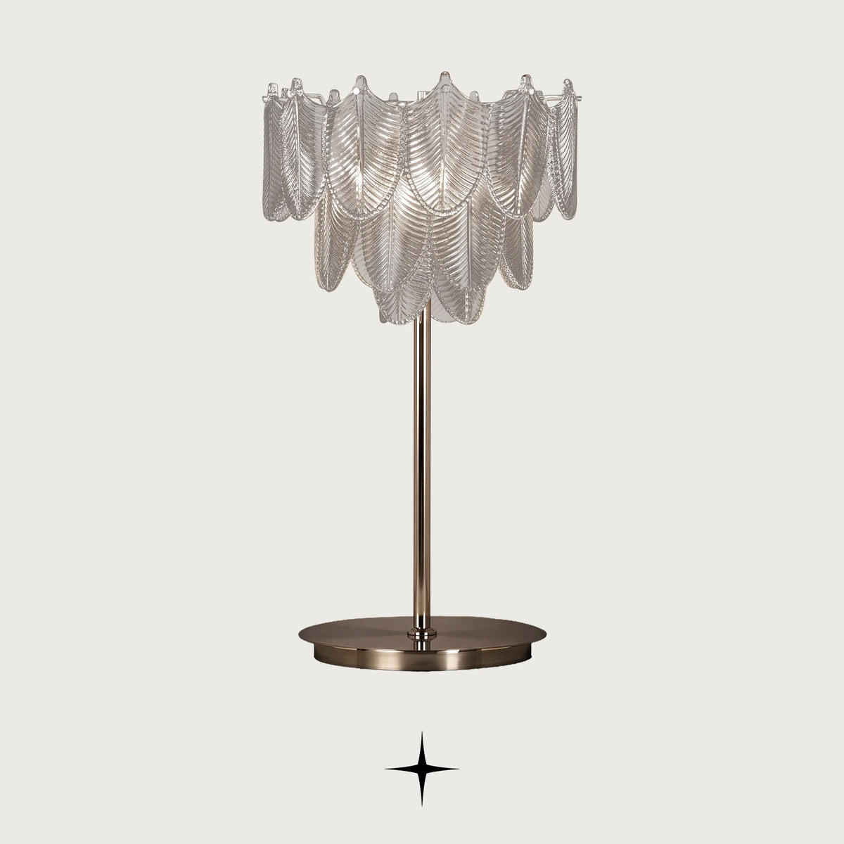 Nola Murano style glass leaf table lamp with golden nickel base on a light grey background