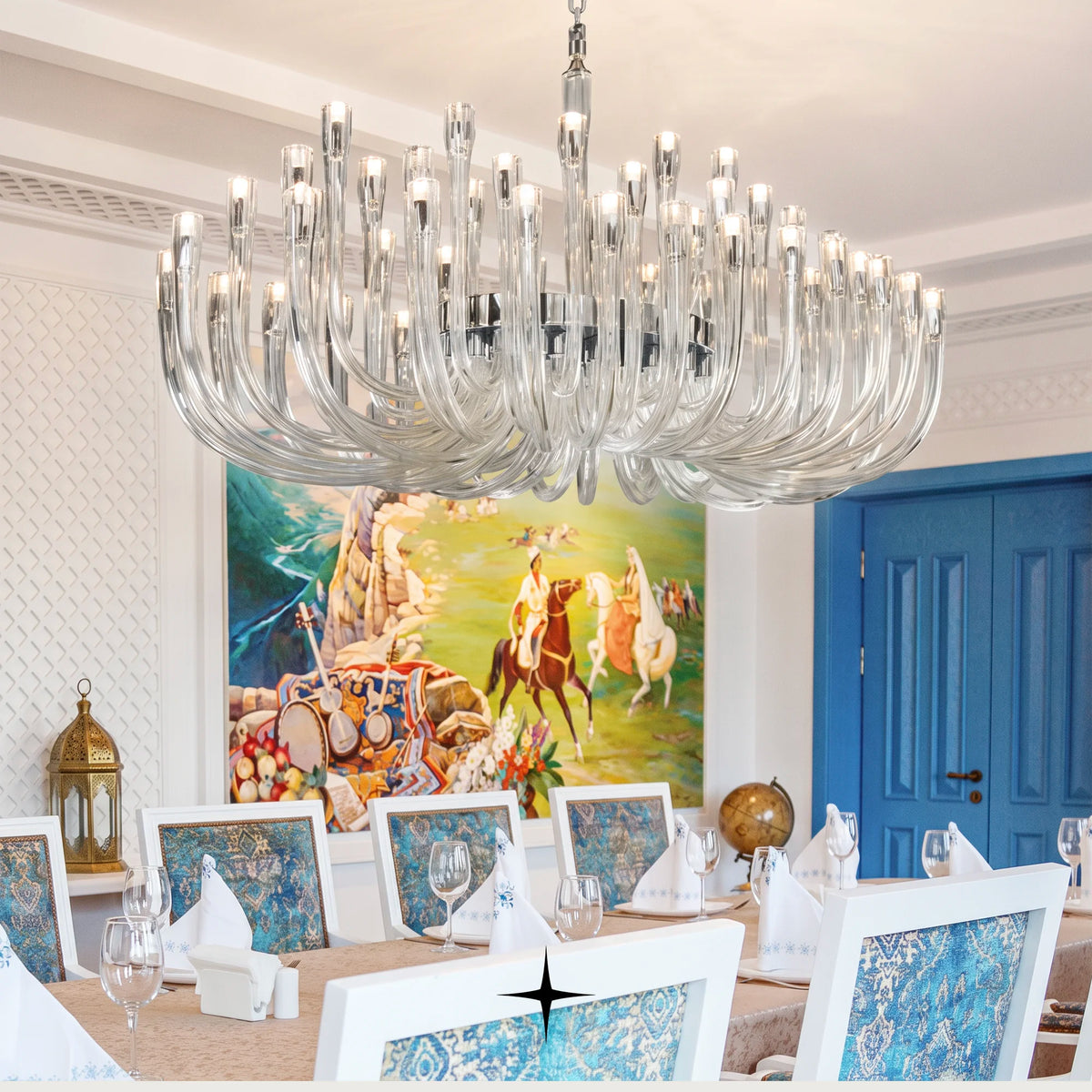 Oval Bliss oval crystal chandelier hanging above a dining table in an elegant interior