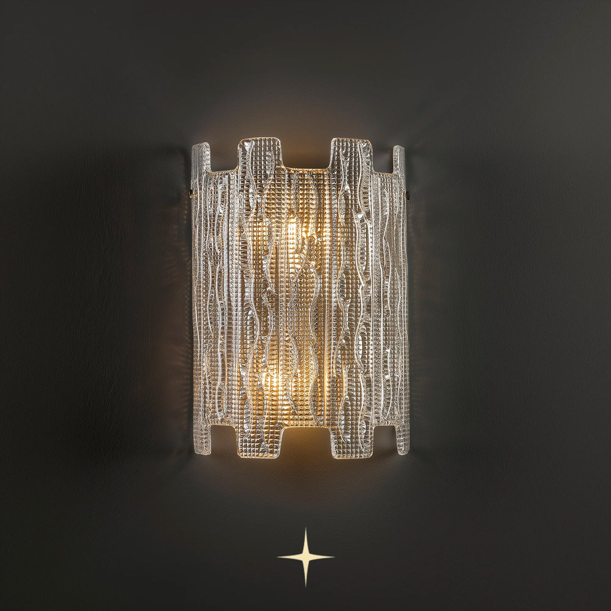 Paloma Murano style textured glass wall sconce illuminated on a dark grey background