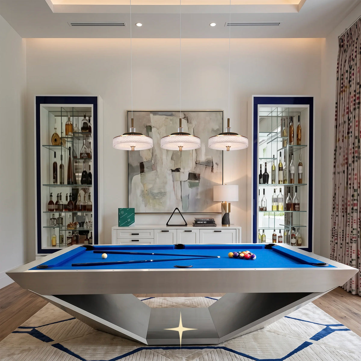 Three Prima Cleo glass pendant lights suspended over a modern billiard table in a luxury game room