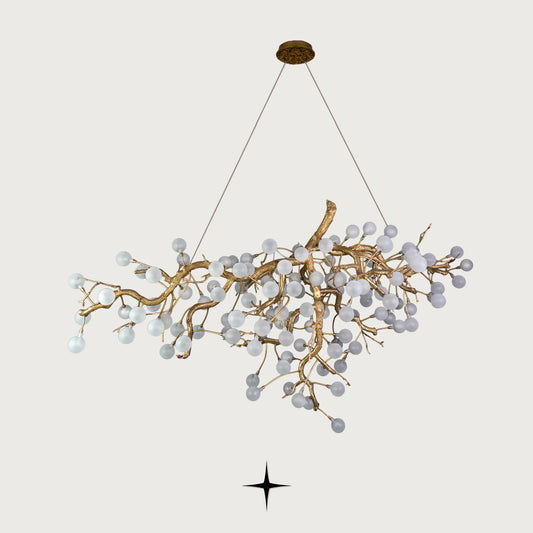 Romantica brass tree branch chandelier with crystal blossom bulbs on light grey background