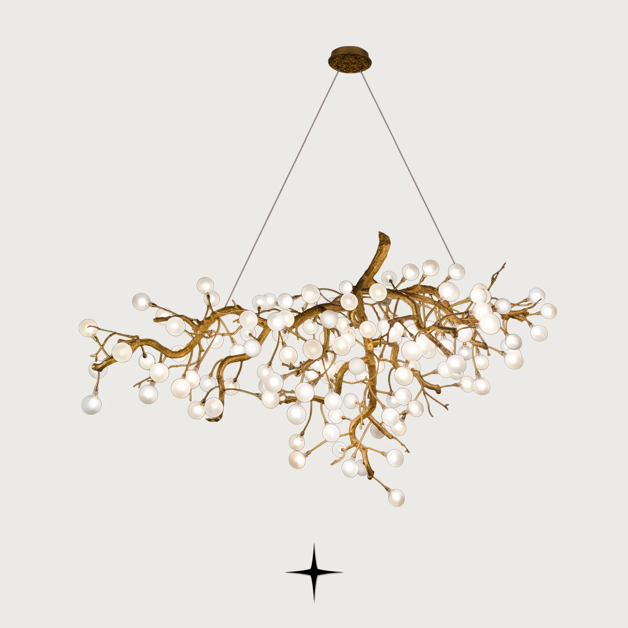 Romantica brass tree branch chandelier with crystal blossom bulbs on light grey background