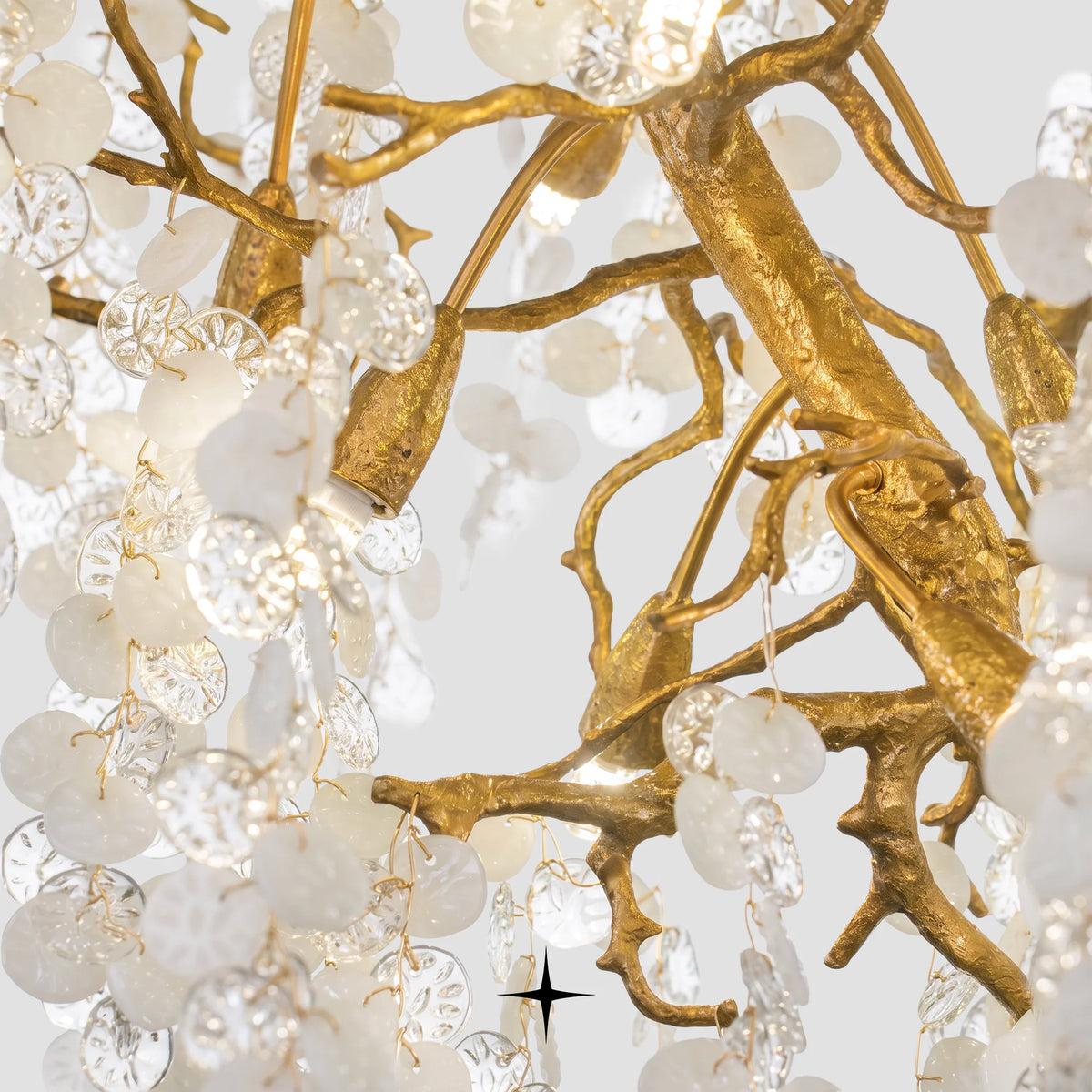 Close-up detail of textured gold brass branches and clear crystal clusters on Shiraz chandelier