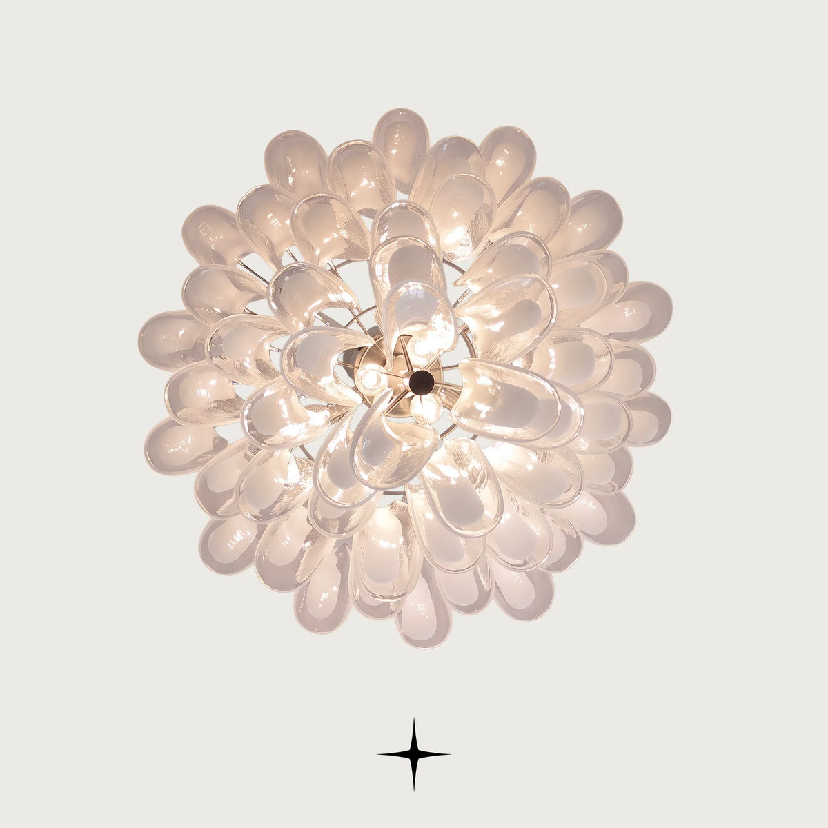 Looking up at the illuminated Murano style glass tears of Tranquility chandelier on light grey background
