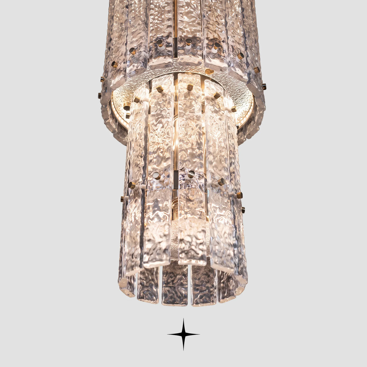 Bottom angle view of illuminated rock-crystal glass tiers on Two Level Chime chandelier