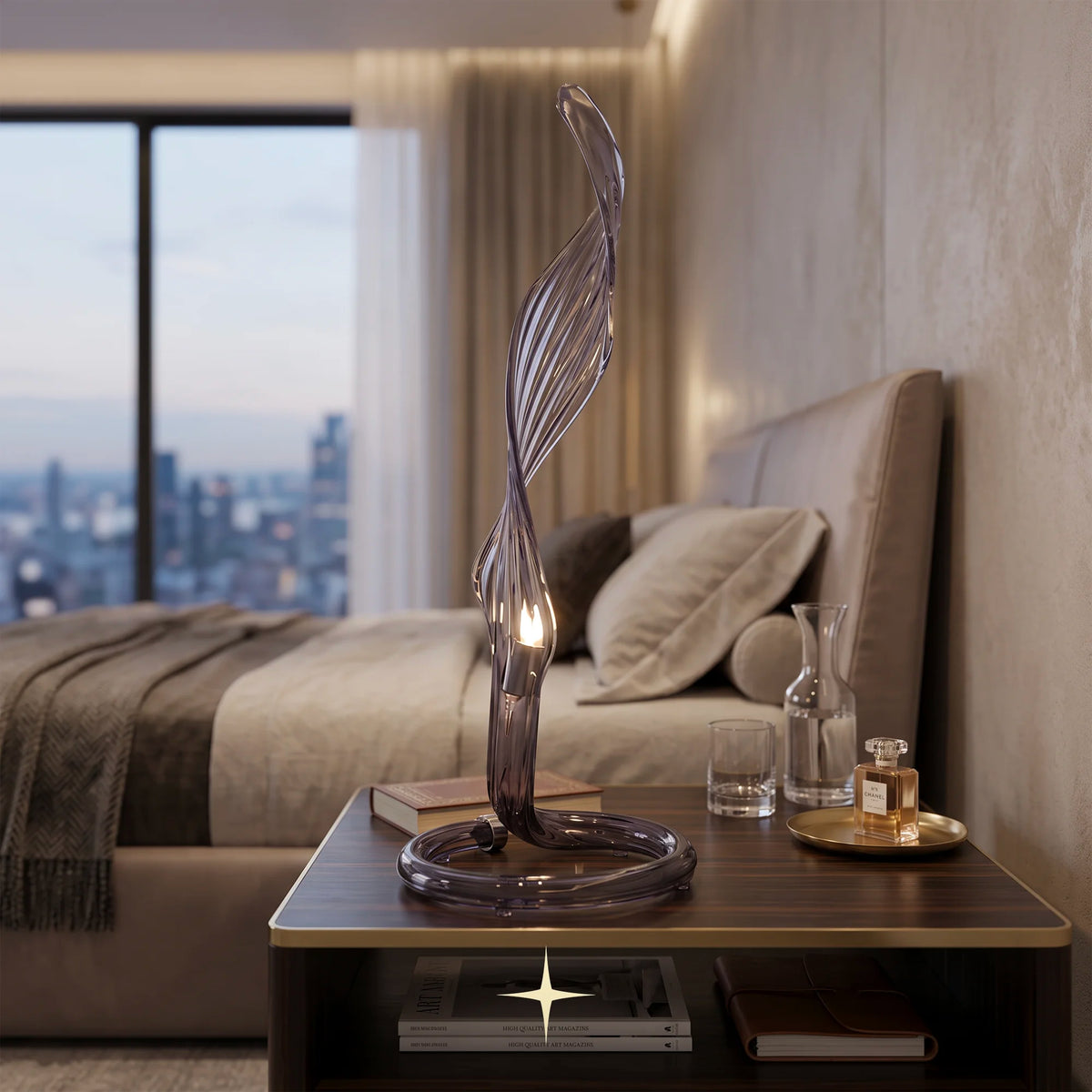 Uma modern sculptural table lamp with curved crystal arms with a twisted, flowing glass stem and a glowing bulb, placed on a dark wood nightstand in a softly lit bedroom.
