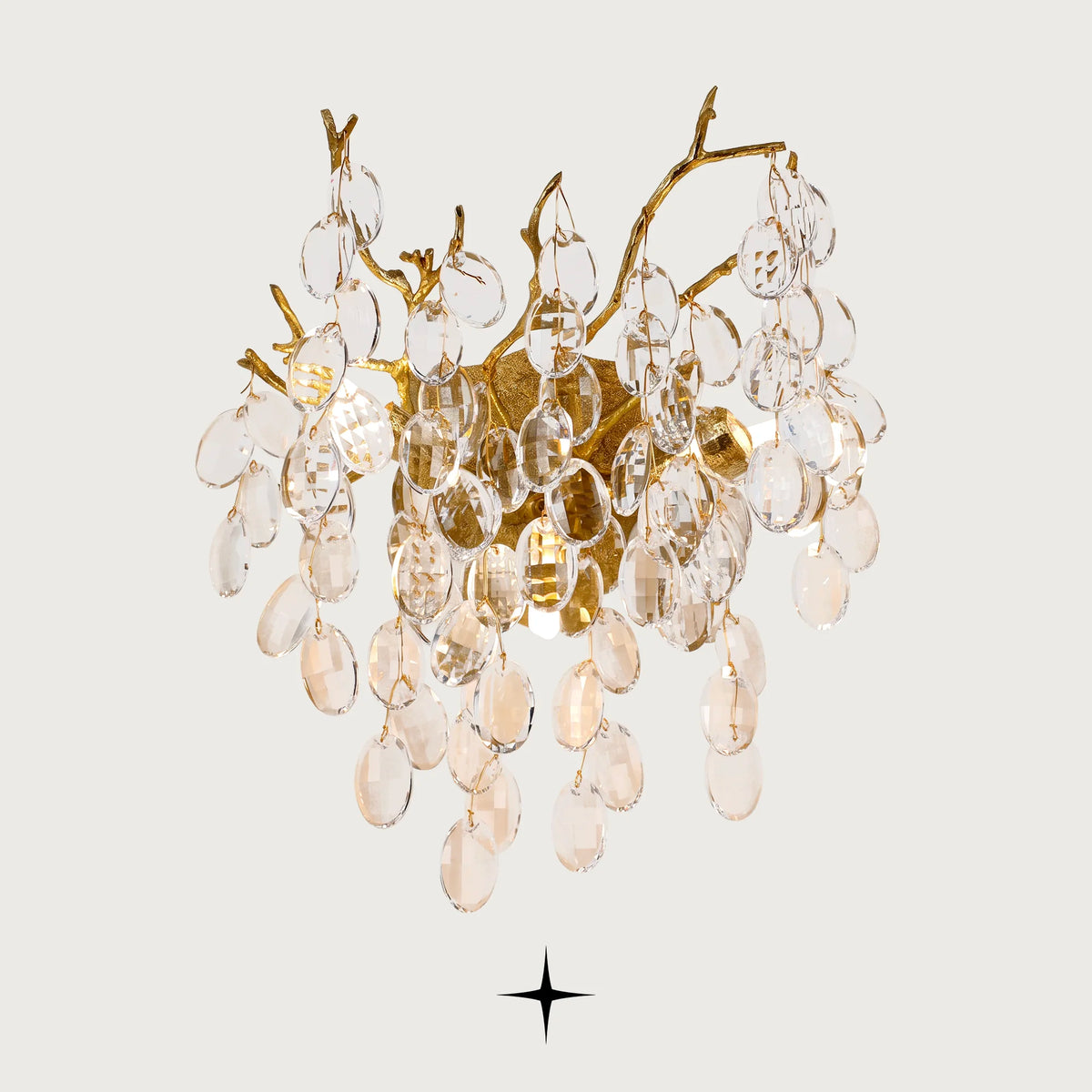 Zinnia crystal branch wall sconce with gold brass frame and clear crystal drops on light grey background
