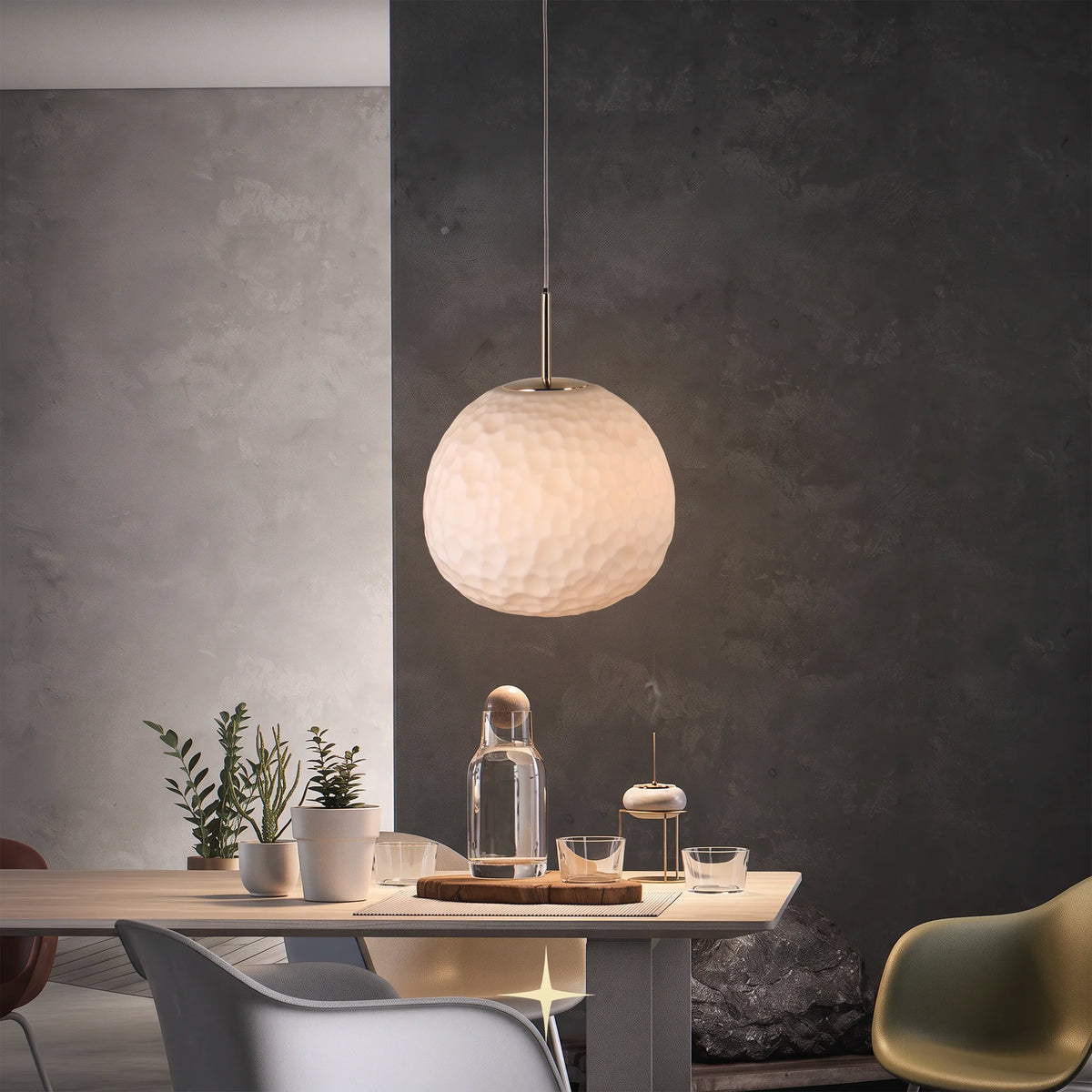  Elegant Zara glass sphere pendant light hanging above a sleek modern dining table and gray wall interior