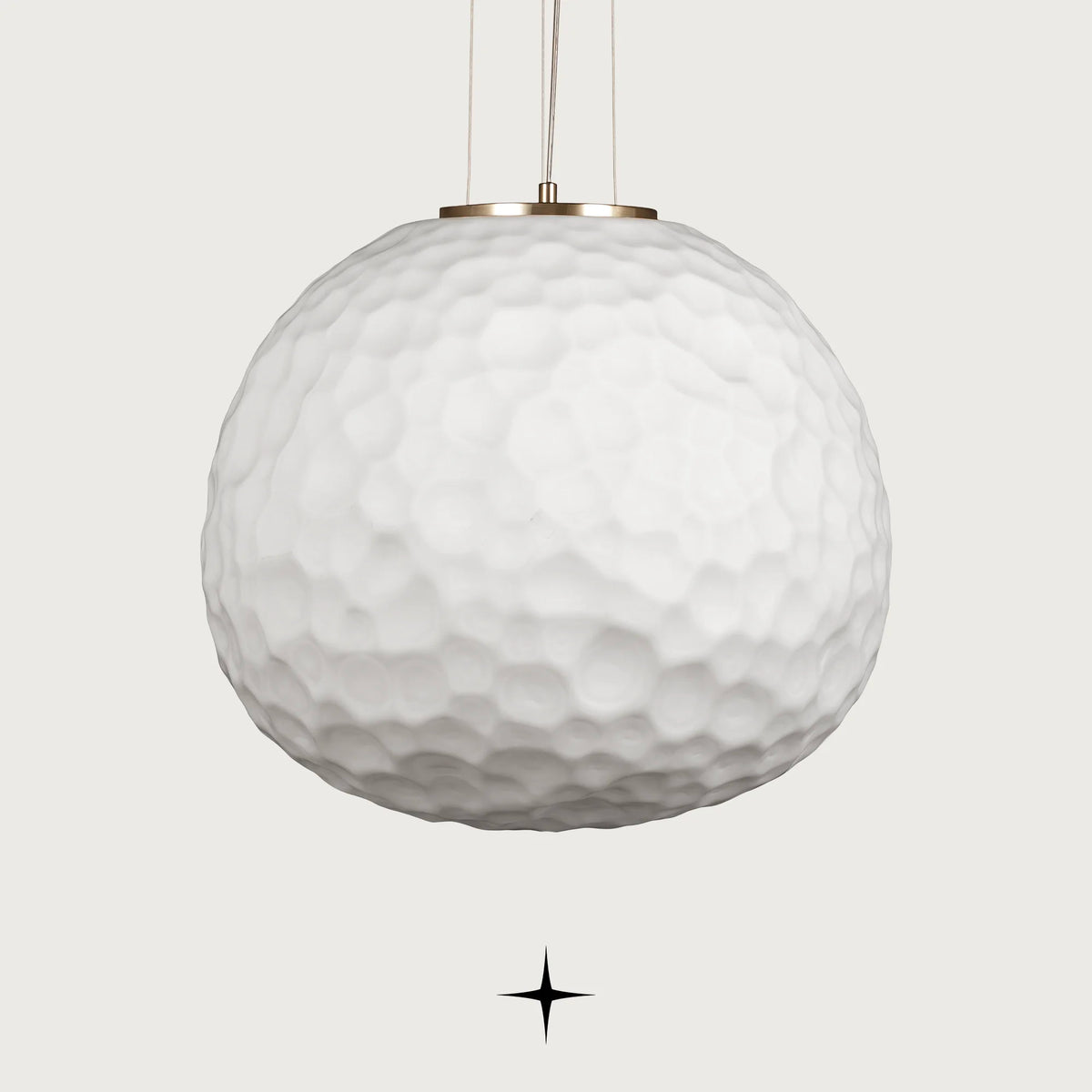 Lavish Zara single light pendant featuring an oversized white textured glass sphere with gold hardware on black background