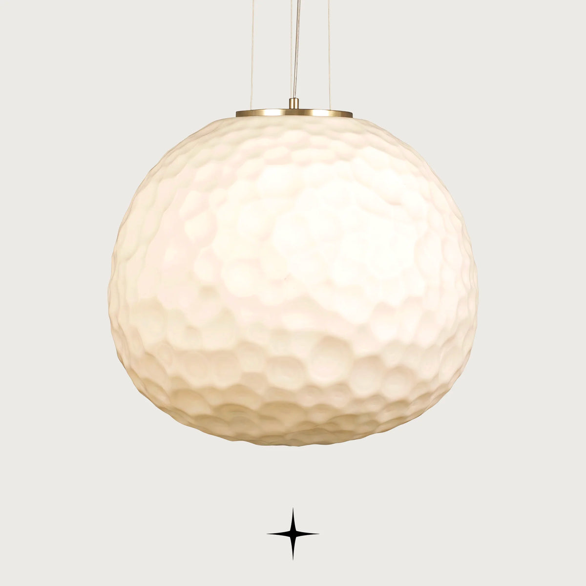 Lavish Zara single light pendant featuring an oversized white textured glass sphere with gold hardware on black background