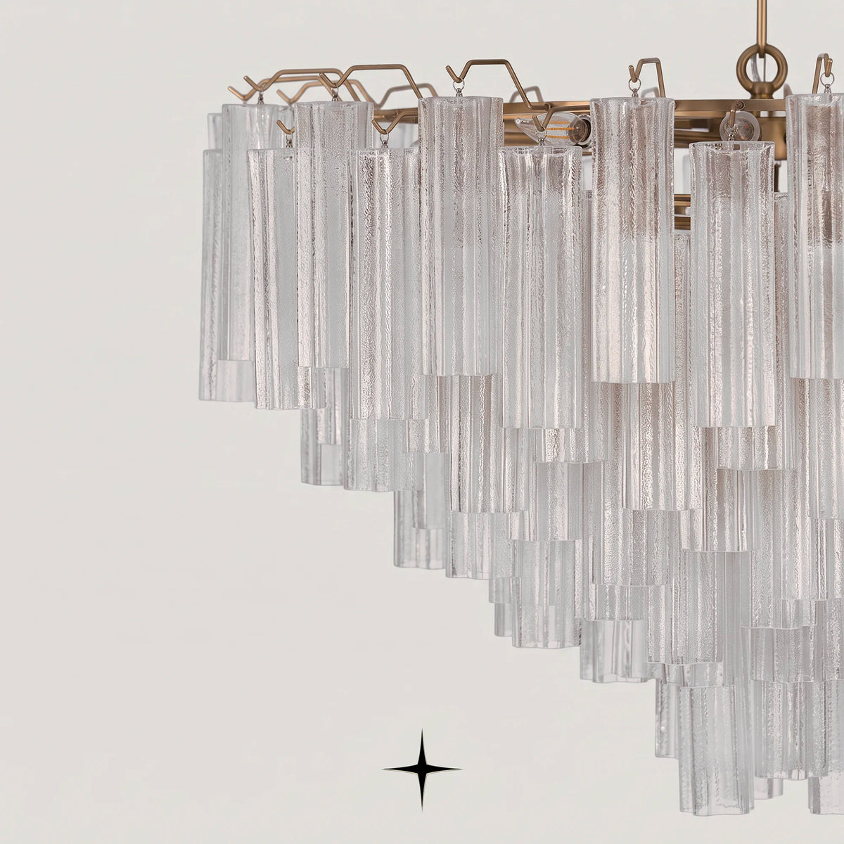 Detailed view of brass structure and layered clear glass tubes on Astra fixture