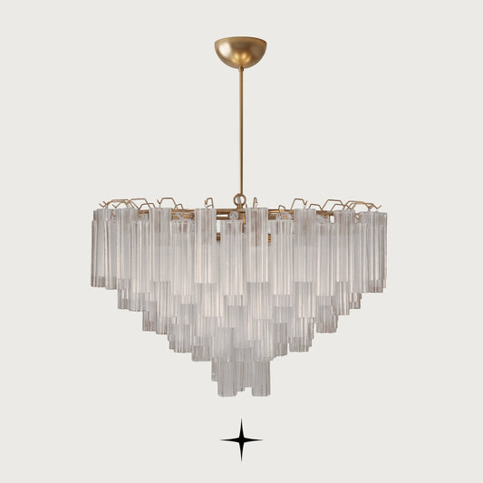 Astra round brass chandelier with cascading fluted ribbed glass tubes on light grey background