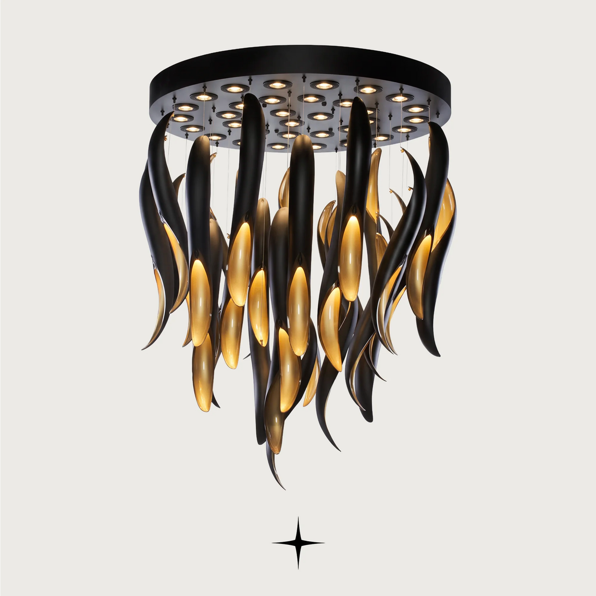 Darken Chandelier featuring a striking contrast of a dripping matte black layer over radiant golden crystals.
