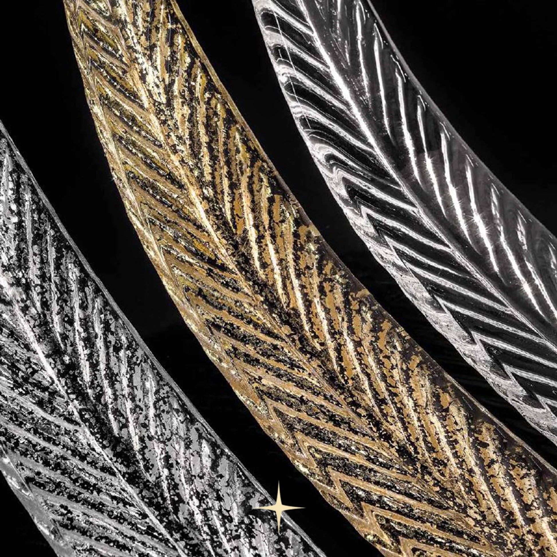 Close-up detail of textured gold and clear glass feather leaves on Elegant Golden Falls chandelier