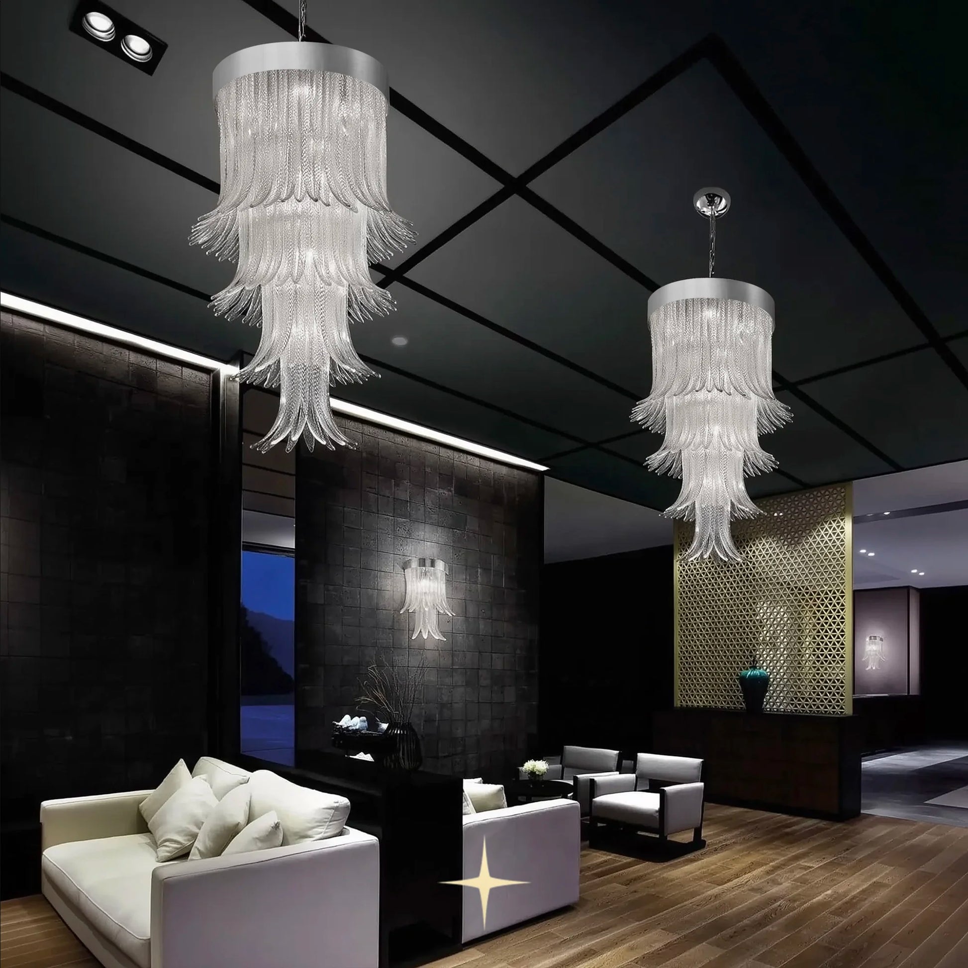 Elegant Golden Falls chandeliers and matching wall sconce in a dark modern luxury lounge setting