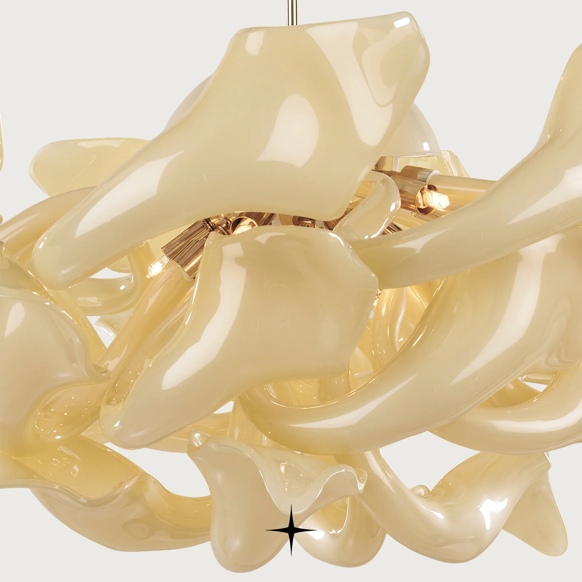 Elegant Naria Chandelier featuring chic elongated golden crystal arms in multi-tier configurations

