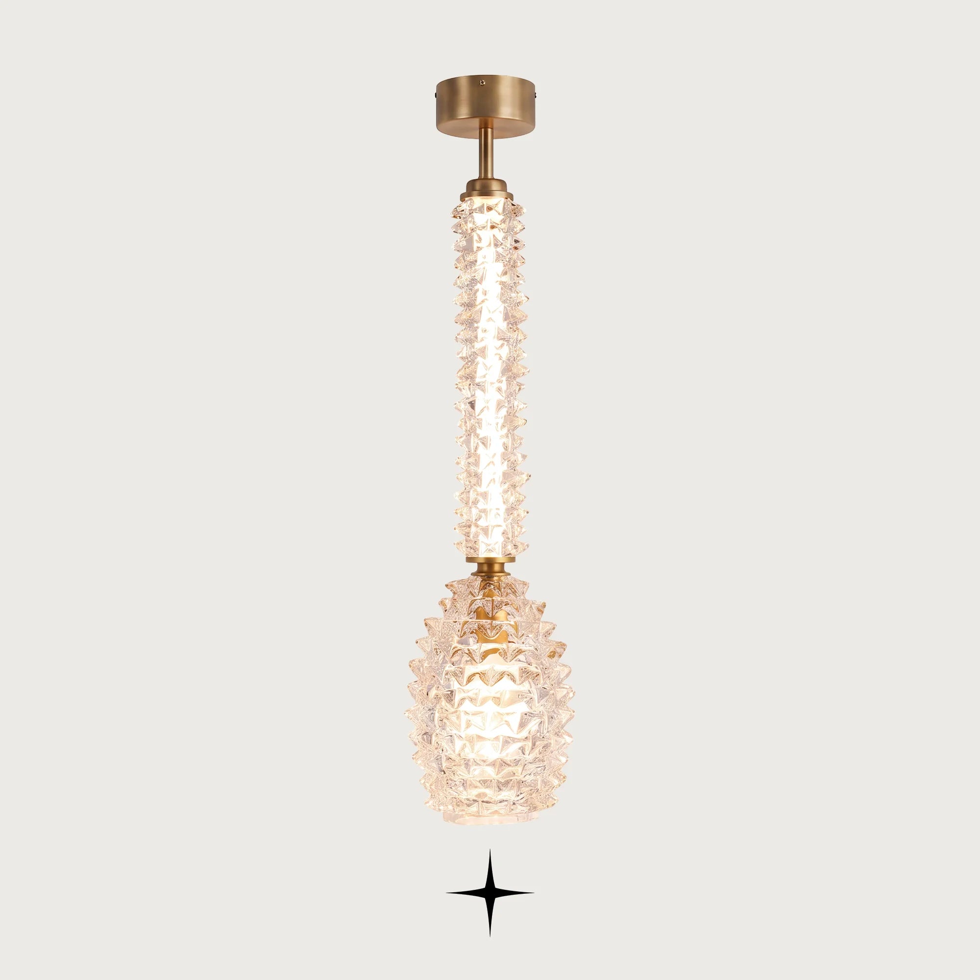 Elegant Sahara clear Murano glass vertical pendant light with golden stem on light grey background
