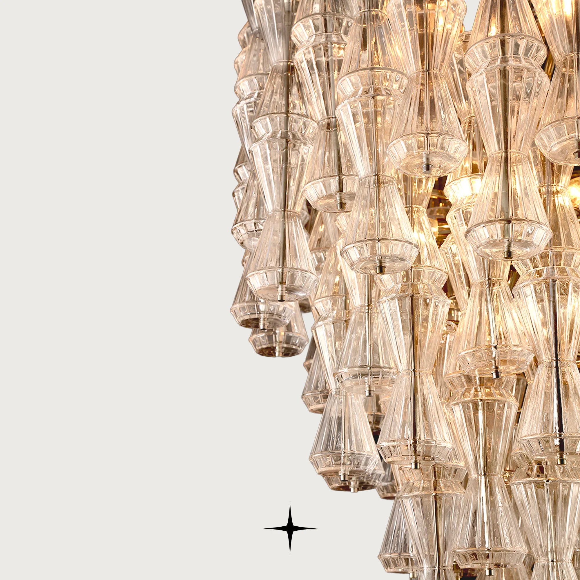 Front view of Elegant Seattle glass hourglass pendant lighting fixture on light grey backdrop

