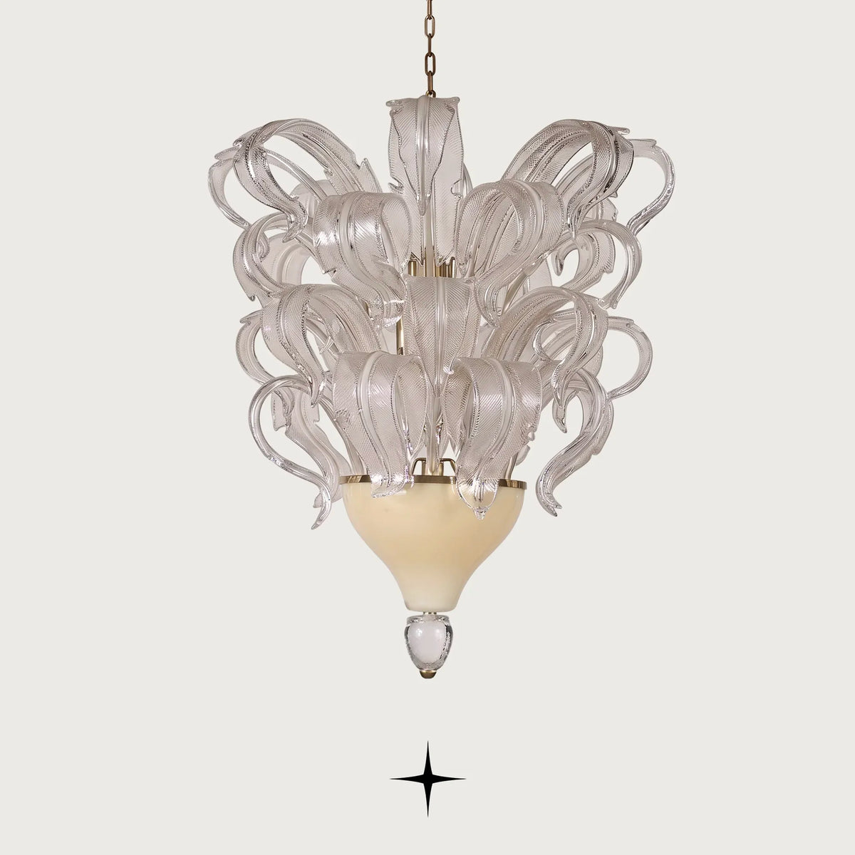 Evangeline Chandelier featuring opulent sculpted glass feathers resting upon a refined gold-accented base
