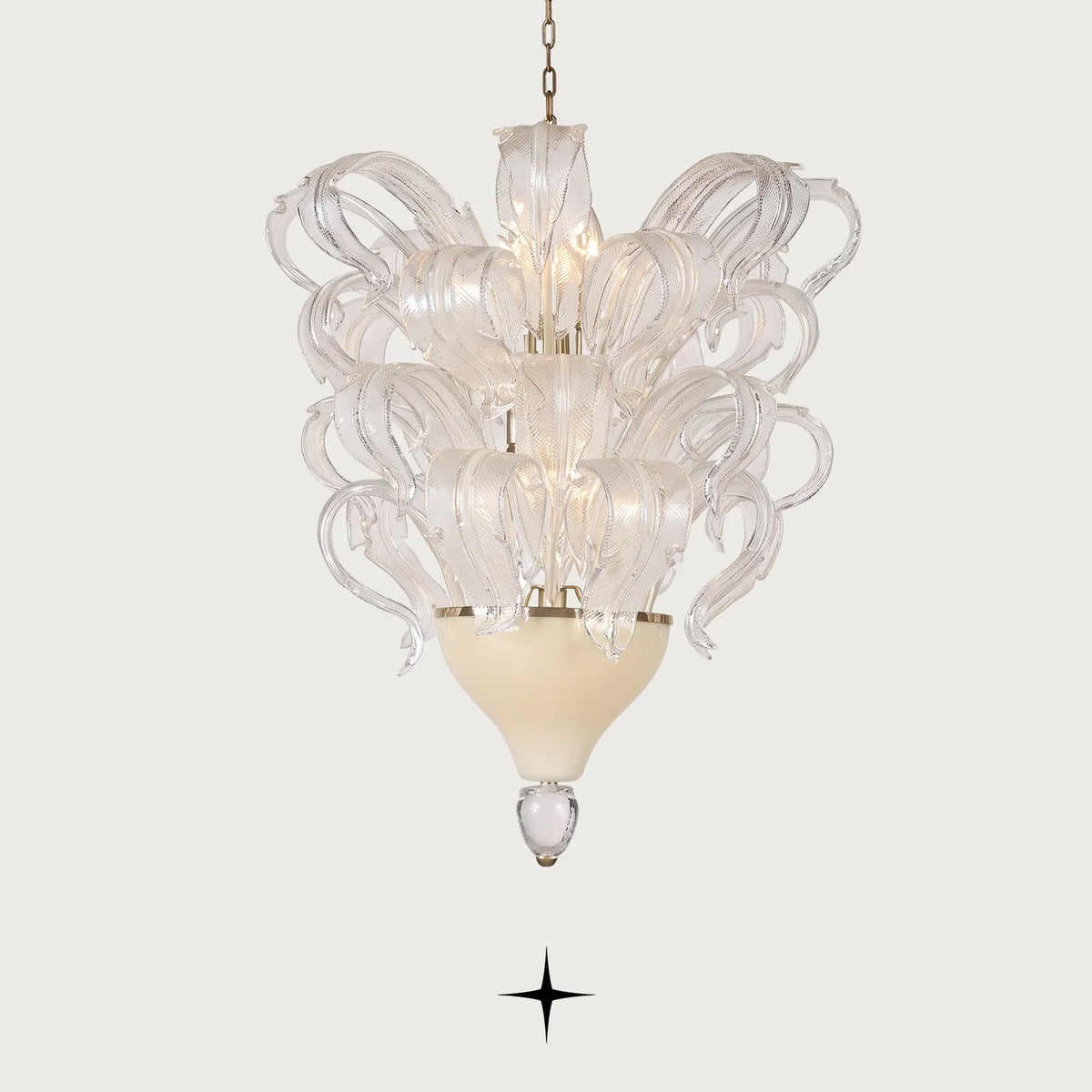 Evangeline Chandelier featuring opulent sculpted glass feathers resting upon a refined gold-accented base
