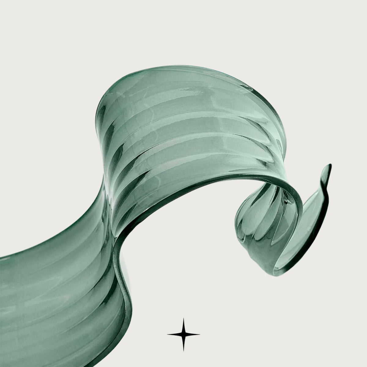 Flux modern chandelier featuring fluid green glass loops suspended from black hardware
